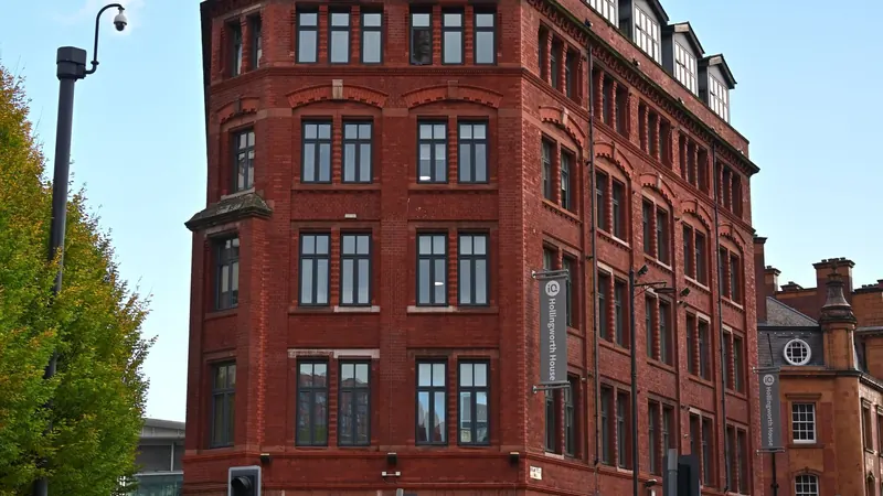 Red-brick buildings on a busy street in Greater Manchester